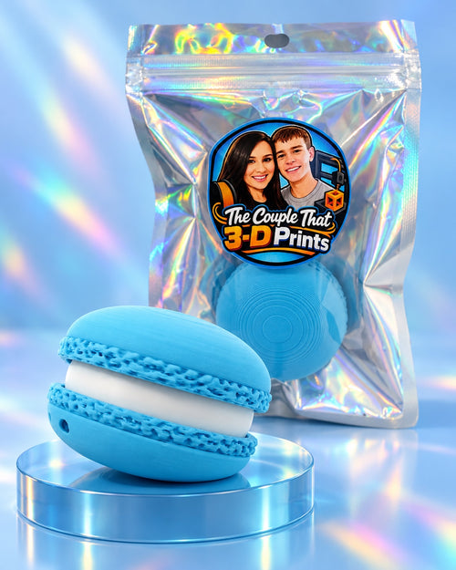 Blue macaron-inspired 3D-printed fidget in holographic The Couple That 3-D Prints packaging